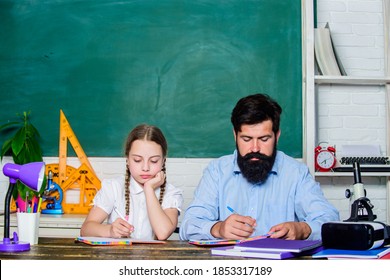 Strict pedagogue. Pedagogue skills. Doing hometask paperwork. Private lesson. Homeschooling with father. Tired kid unmotivated study learn. School teacher and schoolgirl. Man bearded pedagogue.