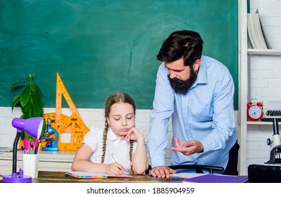 Strict pedagogue. Pedagogue skills. Doing hometask paperwork. Tired kid unmotivated study learn. Private lesson. Homeschooling with father. School teacher and schoolgirl. Man bearded pedagogue.