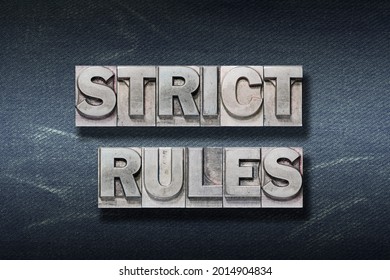 Strict Rules Phrase Made From Metallic Letterpress On Dark Jeans Background