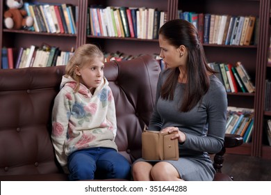 Strict young mother scolding little girl about money