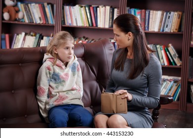 Strict young mother scolding little girl about money