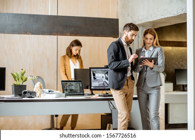 Strictly dressed office employees working with digital tablet and computers at the architectural bureau. Concept of an architectural business and digital designing - Shutterstock ID 1567726516