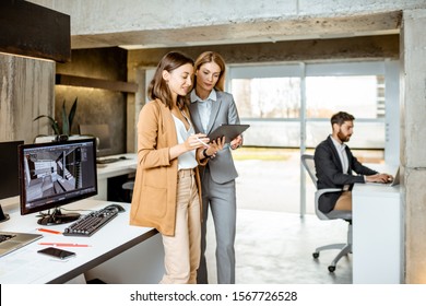 Strictly dressed office employees working with digital tablet and computers at the architectural bureau. Concept of an architectural business and digital designing - Shutterstock ID 1567726528