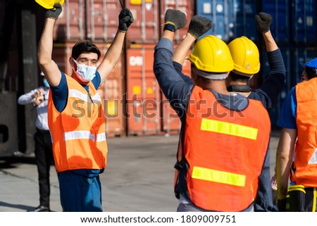 Strike of workers in container yard. Group of multiethnic engineer people during a protest in workplace