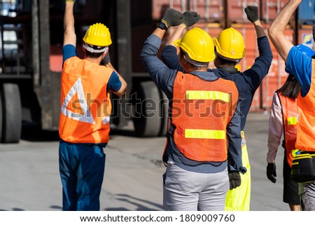 Strike of workers in container yard. Group of multiethnic engineer people during a protest in workplace