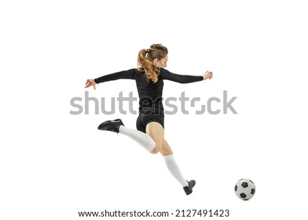 Striker. Professional female soccer, football player in action, motion isolated on white studio background. Concept of sport, fitness. Young sportive girl in motion. Copy space for ad, text