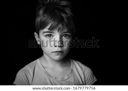 Striking blank and white portrait of a young girls with short hair