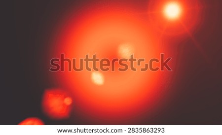 A striking digital image showcasing a dramatic red and orange lens flare, emphasizing light and photographic realism. Perfect for creative and cinematic visual effects.