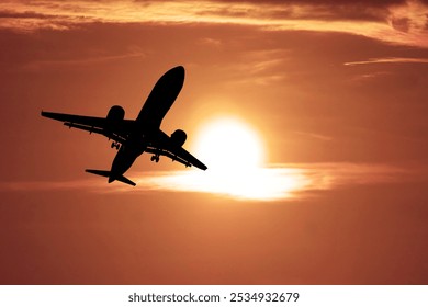 A striking image of an airplane silhouette flying against a vivid orange sunset, capturing the essence of travel and adventure. - Powered by Shutterstock