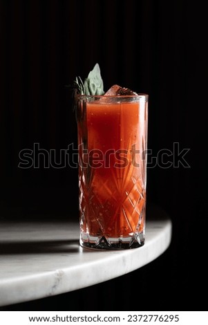 A striking image featuring a Bloody Mary cocktail, garnished with celery and olives, exuding a bold and savory appeal. Perfect for promoting a classic and invigorating beverage choice.