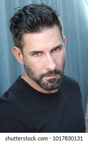 Striking man with neutral expression close up