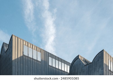  A striking modern architectural building with a sleek design, featuring large windows and a metal facade. - Powered by Shutterstock