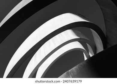 Striking monochrome architectural feature with sweeping curves and a dynamic interplay of light and shadow