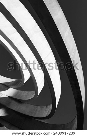 Striking monochrome architectural feature with sweeping curves and a dynamic interplay of light and shadow