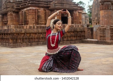 Striking pose of an odissi dancer against the backdrop of Mukteshvara Temple,Bhubaneswar, Odisha, India