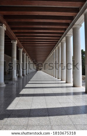Striking view of columns casting deep shadows in Agora in Athens Greece