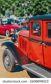 Striking vintage red car lively car show of retro cars. Vintage car evokes nostalgia, elegance, timeless design. Classic car show featuring vintage vehicles, Sofia, Bulgaria