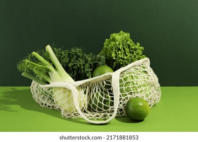 String Bag With Vegetables And Fruits On Two Tone Background