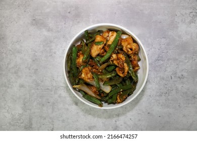 String bean chicken breast with mild ginger soy sauce served in a white bowl.