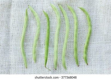 string bean on white fabric background