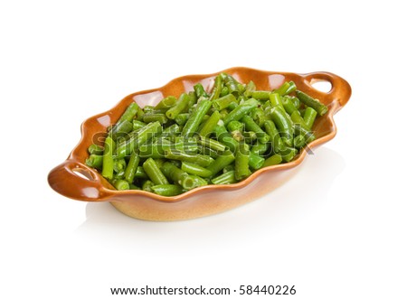 String beans with garlic in a brown bowl. Isolated on white by clipping path.