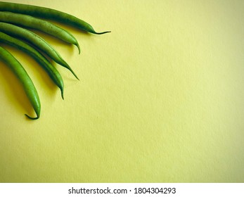 String beans on Yellow background. Closeup shot : selective focus. Copy space.
