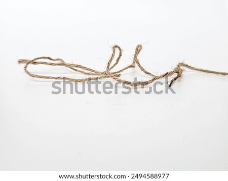 String bow isolated on white background. Jute rope bows, packaging cord knots, knotted rustic gift, eco-friendly natural rope bow.