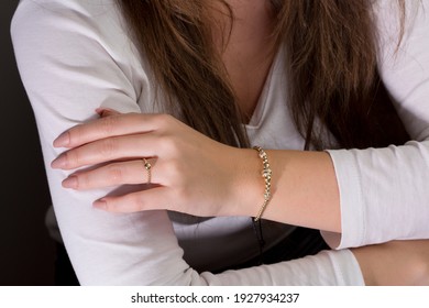 String bracelets designed with gold and beads on the arm of the young lady.