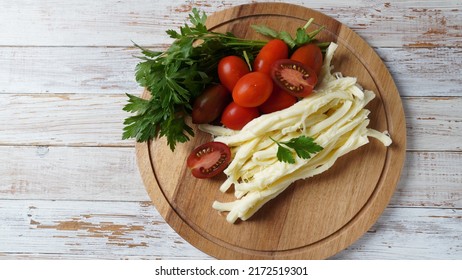 String Cheese Or Cheese Whip - Salty Snack Cheese With Cherry Tomatoes And Herbs On Chopping Board. Turkish Cheese