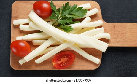 String Cheese Or Cheese Whip - Salty Snack Cheese With Cherry Tomatoes And Herbs On Chopping Board. Turkish Cheese