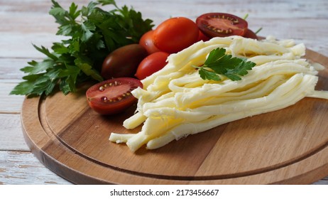 String Cheese Or Cheese Whip - Salty Snack Cheese With Cherry Tomatoes And Herbs On Chopping Board. Turkish Cheese