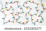 String of Christmas lights on white background. Colourful Christmas decoration.
