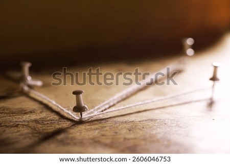 String Connected Push Pins on Map Representing Navigation and Travel Planning Concept