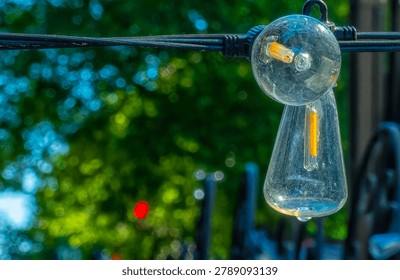 A string of festive light bulbs on a pation                               