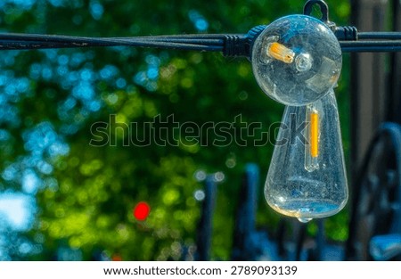 A string of festive light bulbs on a pation                               