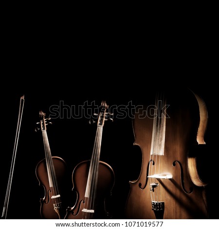 String instruments isolated. Violin, viola and cello orchestra instrument. Classical music instruments isolated on black background