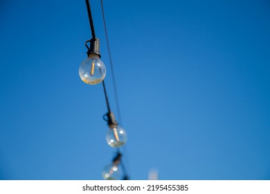 A string of light bulbs and blue sky in Penghu, Taiwan.