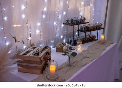 
String lights and candles on a table for a wedding.
