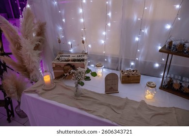
String lights and candles on a table for a wedding.