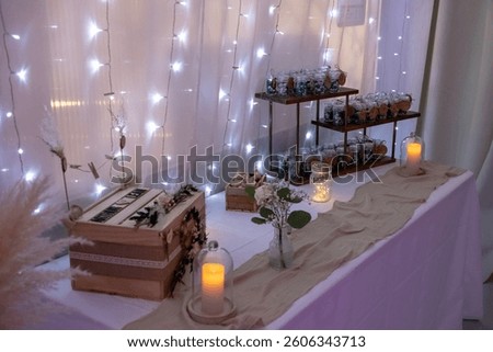 
String lights and candles on a table for a wedding.