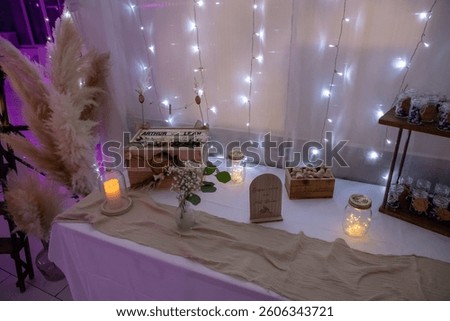 
String lights and candles on a table for a wedding.