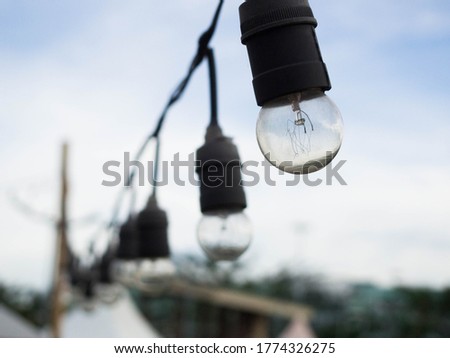 A string of lights in the daytime.