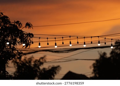 String lights hanging as decorations at typical festivals, in the twilight sky.