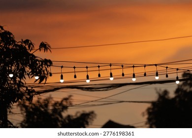 String lights hanging as decorations at typical festivals, in the twilight sky.