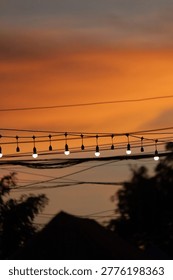 String lights hanging as decorations at typical festivals, in the twilight sky.