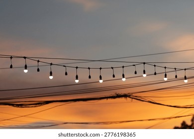 String lights hanging as decorations at typical festivals, in the twilight sky.