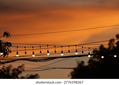 String lights hanging as decorations at typical festivals, in the twilight sky.