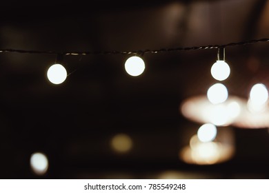 A String Of Mini Golf Ball Light Bulbs With Bokeh Effect In The Background