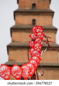 String Of Red Chinese Kites With Pagoda In The Background. 