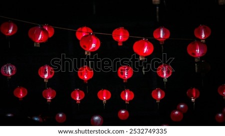 A string of red lanterns hanging . traditional Chinese lanterns . lunar new year . Chinese new year